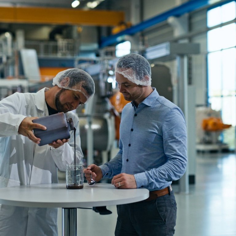Technology Center in Dresden - our test and training center Two men standing in the technology center in Dresden, testing material