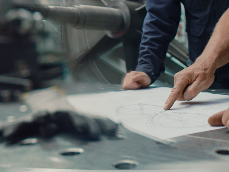 PROBAT certificates Hands pointing on paper plan in factory