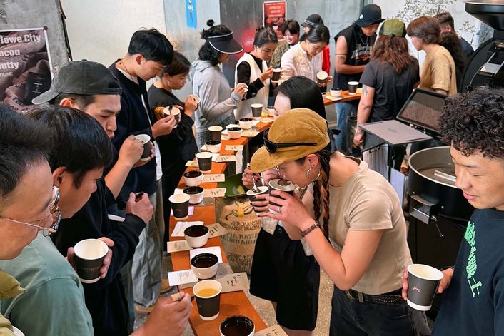 Espresso Master Roaster Beans The picture shows man people at an exhibition testing roasting beans.
