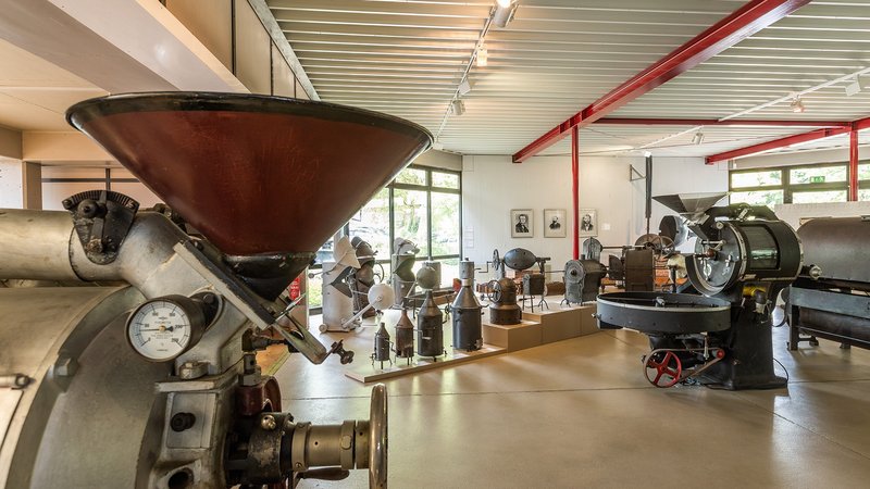 Museum room with various roasters in it