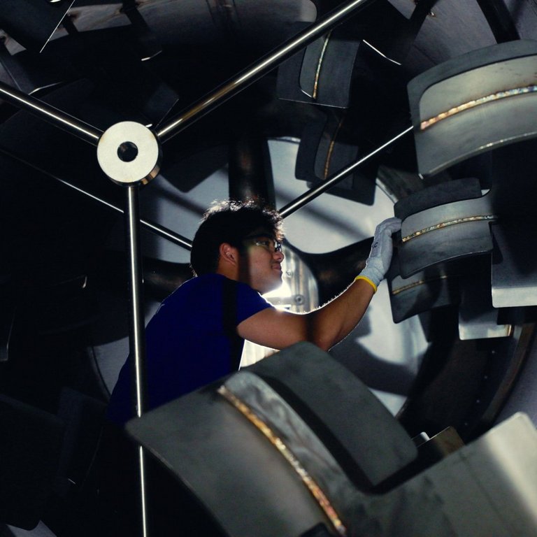 PROBAT Service - your Trusted Support Throughout the Product Lifecycle.jpg A service employee stands in the drum of a machine and performs maintenance work