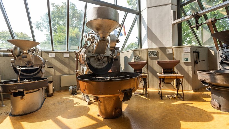 Old drum roaster in museum with big window in background